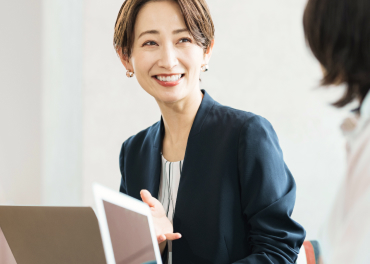 パソコンを前に微笑む女性